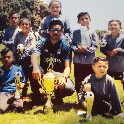 La Esperanza youth players celebrating with trophies