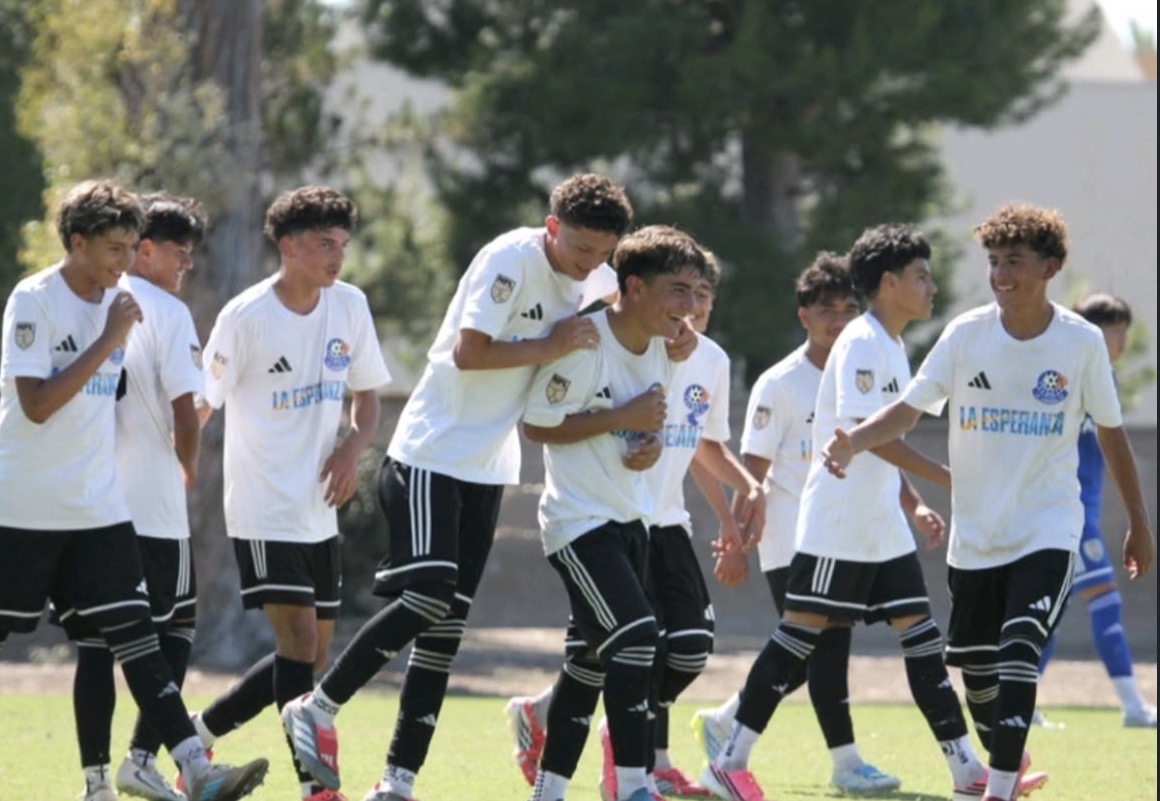 N1 B2010/11 players celebrating a goal in white La Esperanza kits