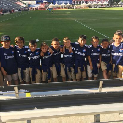 Young La Esperanza team visiting a soccer stadium